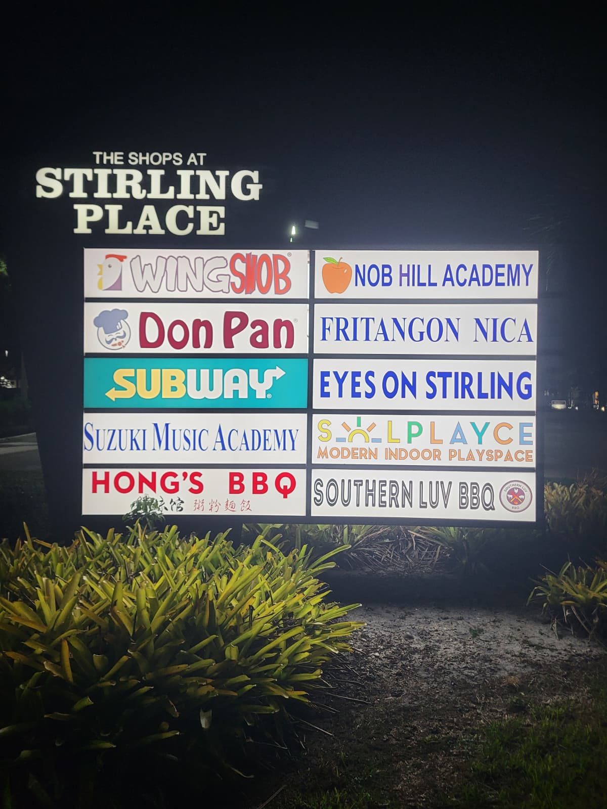The Shops at Stirling Place sign listing Southern Luv BBQ