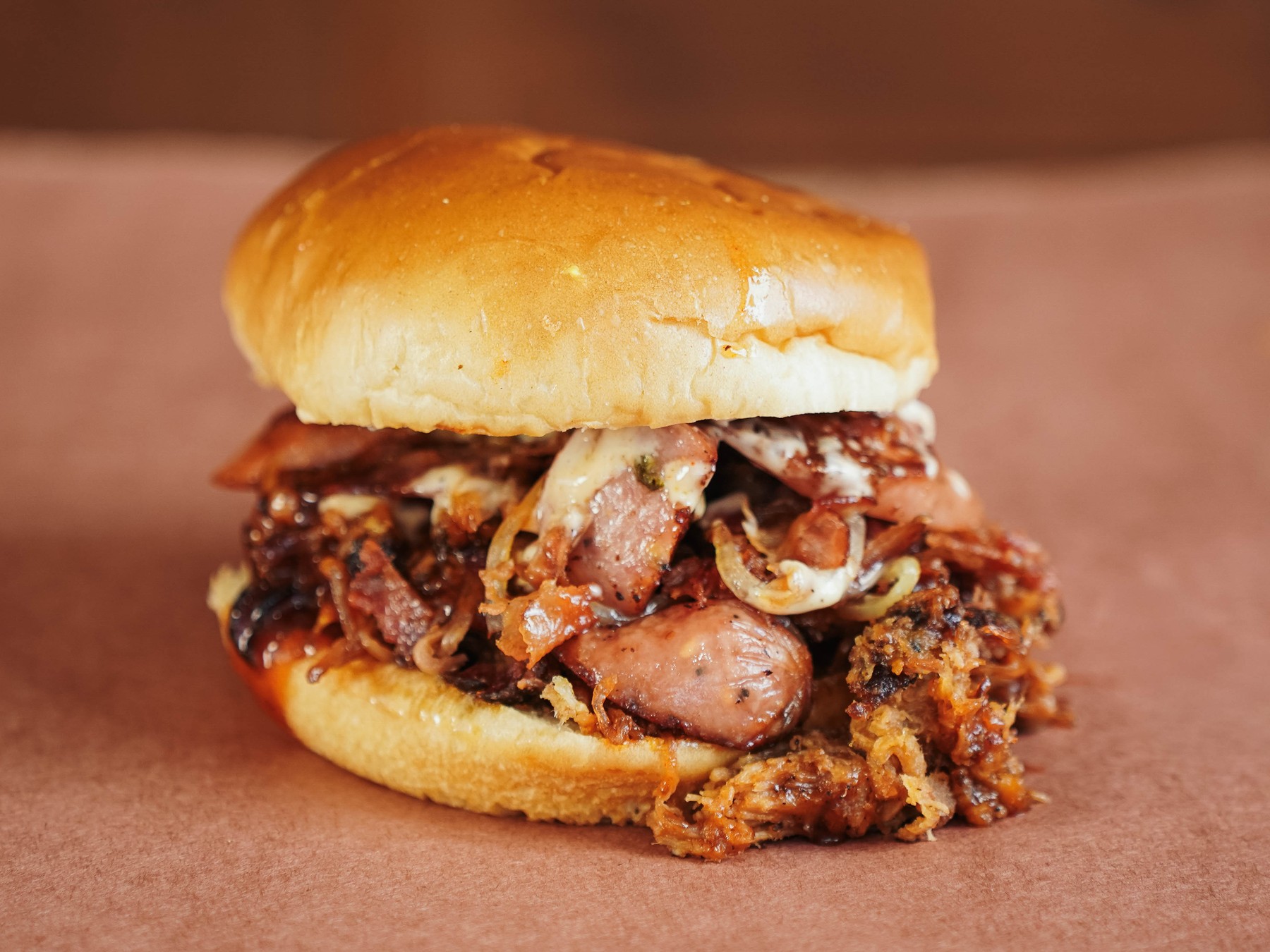 Alabama-Slamma — Pulled pork, bacon, smoked sausage, caramelized onions, and Bama sauce.