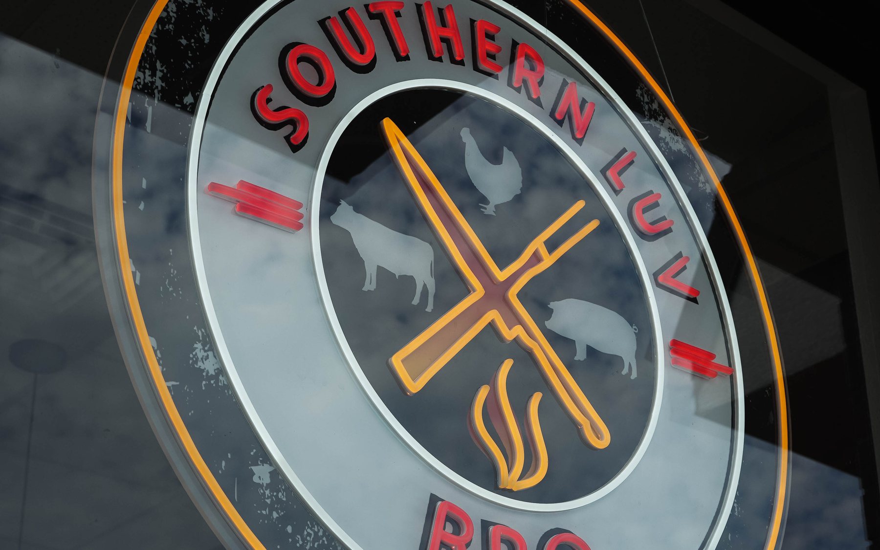 The Southern Luv BBQ neon sign lit at the Citrus Park location
